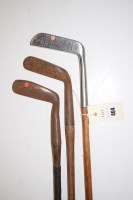 Lot 404 - Three hickory shafted iron headed putters...