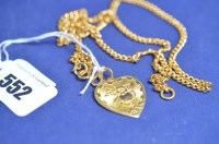 Lot 552 - A Chinese yellow metal heart-shaped pendant,...
