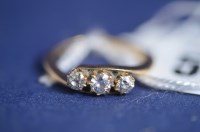 Lot 585 - A three stone diamond ring, the brilliant cut...