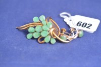 Lot 602 - A green stone and yellow metal floral pattern...