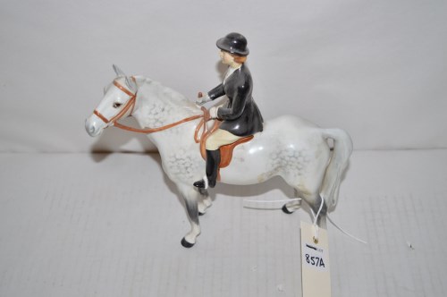 Lot 857 - A Beswick figure of a lady and dapple grey horse.