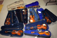 Lot 1545 - Nine violins, mostly with bows and all in...