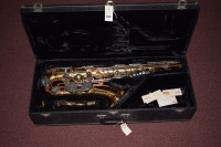 Lot 1549 - A Vito tenor saxophone in brass with metal...