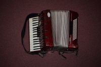 Lot 1553 - Am Amigo Bell piano accordion, in red wood...