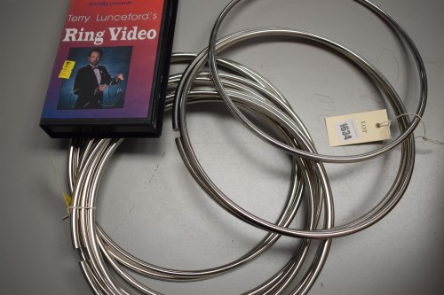 Lot 1634 - A set of stainless steel magic ring trick...