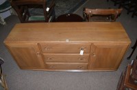 Lot 1131 - An Ercol elm sideboard, with three short...