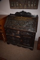 Lot 1212 - A Victorian ebonised carved oak bureau the...