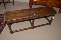 Lot 1224 - A carved oak hall bench, raised on turned legs...