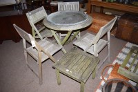Lot 833 - A circular teak folding garden table with...