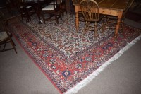 Lot 903 - A modern Persian hand knotted rug on cream...
