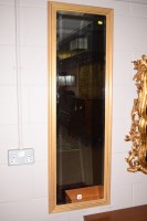 Lot 927 - A modern rectangular bevelled mirror in gold...