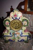 Lot 948 - A Victorian mantel clock in ornate ceramic...