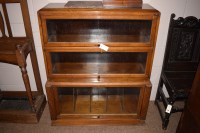 Lot 954 - A pair of oak bookcases each with three up and...