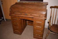 Lot 967 - An early 20th Century oak roll top desk, with...