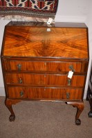 Lot 969 - An early 20th Century figured walnut bureau,...