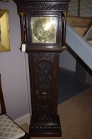 Lot 985 - A longcase clock in heavily carved and stained...