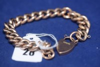 Lot 28 - A 9ct. yellow gold curb link bracelet with...