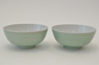 Lot 33 - Pair of carved Chinese celadon bowls, the...