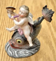 Lot 183 - Sitzendorf figure of a cherub riding a dolphin,...