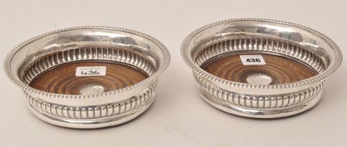 Lot 436 - A pair of George III silver wine coasters, by...