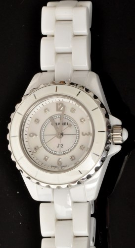 Lot 513 - Chanel: a white ceramic and diamond set quartz...