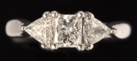 Lot 529 - A three stone diamond ring, the central...