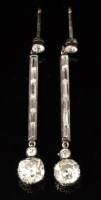 Lot 574 - A pair of diamond drop earrings, each with an...