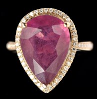 Lot 590 - A ruby and diamond cluster ring, the pear...