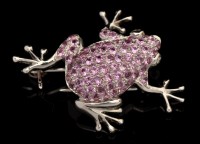 Lot 594 - A pink sapphire and 18ct. white gold frog...