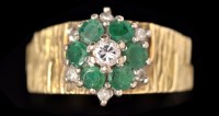 Lot 604 - An emerald and diamond cluster ring, the...