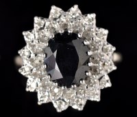 Lot 607 - A sapphire and diamond cluster ring, the...