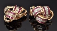 Lot 610 - A pair of ruby and diamond earrings of knot...
