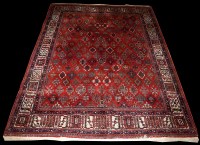 Lot 663 - A Joshagan carpet, with floral sprigs on a red...