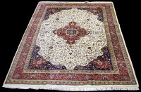 Lot 672 - A Tabriz carpet, the central red floral...