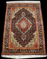 Lot 696 - A Tabriz rug, with flowerhead decoration...