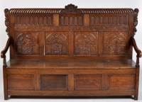 Lot 799 - A Victorian oak settle, the back with angel...