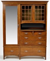 Lot 807 - An Arts & Crafts wardrobe, the flared dentil...