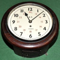 Lot 714 - A circular railway wall timepiece, the white...
