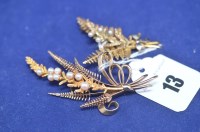 Lot 13 - Two 9ct. yellow gold fern pattern brooches set...