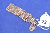 Lot 22 - A 9ct. yellow gold gate link bracelet with...