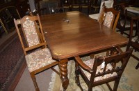 Lot 712 - A 20th Century oak dining suite, to include:...