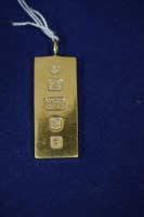 Lot 12 - A 9ct. yellow gold ingot pendant, c.1960,...