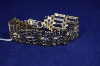 Lot 13 - A 9ct. yellow gold gate link bracelet with...