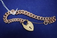 Lot 15 - A 9ct. yellow gold curb link bracelet with...
