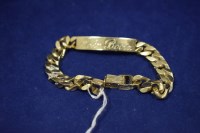 Lot 21 - A 9ct. yellow gold identity bracelet, engraved...