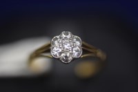 Lot 35 - A diamond cluster ring, the seven...