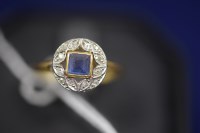 Lot 36 - A sapphire and diamond ring, the central...