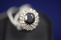Lot 37 - A sapphire and a diamond cluster dress ring,...