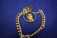 Lot 47 - A 9ct. yellow gold curb link bracelet with...