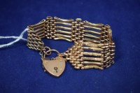 Lot 52 - A 9ct. rose gold gate link bracelet, with...